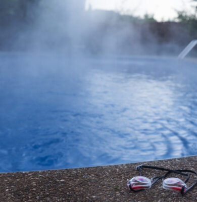 Swim goggles cast aside from an empty swimming pool